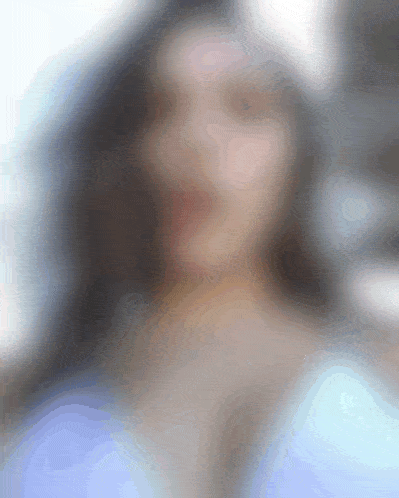 a blurry picture of a woman with long hair