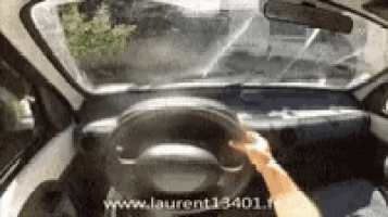 a person is driving a car with the website laurent13401.fr written on the bottom