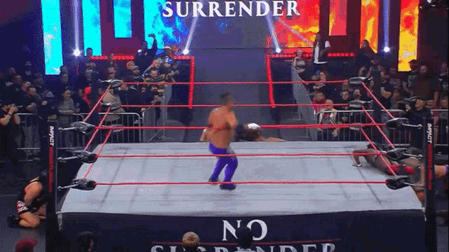 a wrestler in a ring with a sign that says surrender