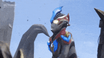 a cartoon character is standing in front of a large rock and a blue sky .
