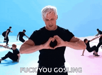 a man is making a heart with his hands in front of a group of people .