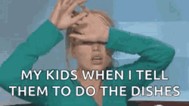 a woman is covering her face with her hands while talking to her children .