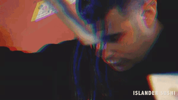 a blurry image of a person eating sushi with the words islander sushi below