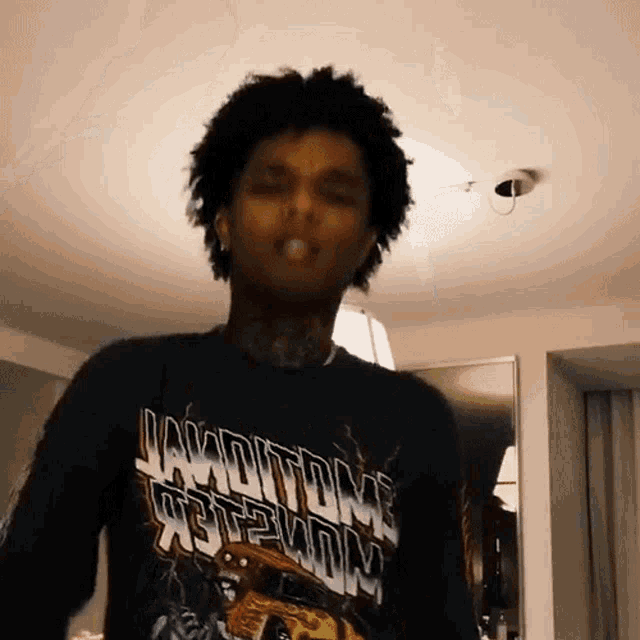 a young man wearing a black shirt that says jaydtown