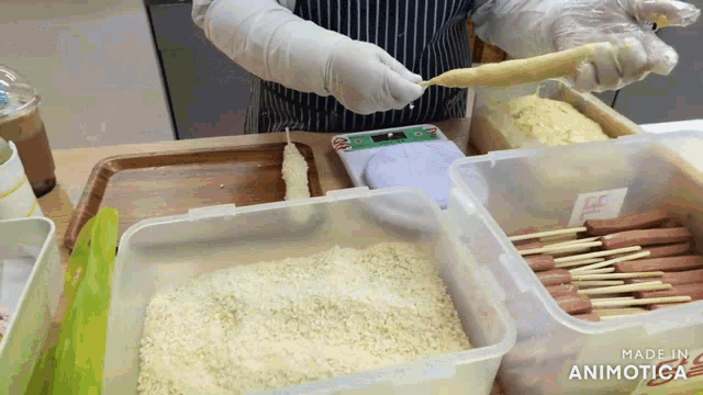 a person is preparing food in a plastic container that says made in animatica