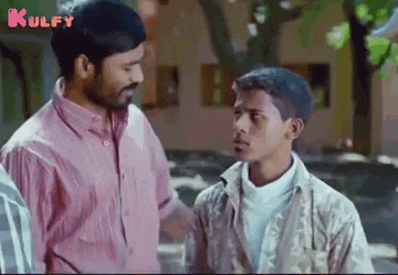 a man and a boy are talking to each other in a movie scene .