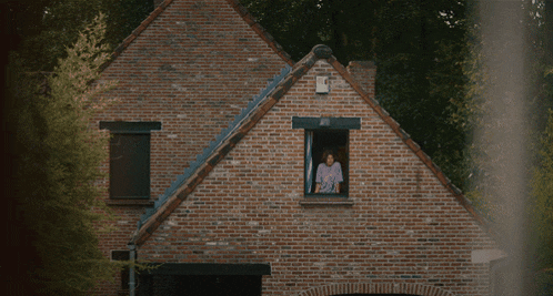a brick house with a white box on the roof that says ' a ' on it
