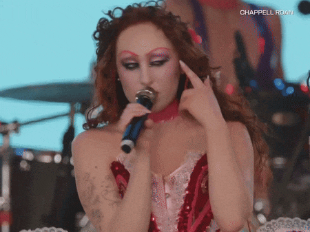 a woman singing into a microphone with the words chappelle roam written on the bottom