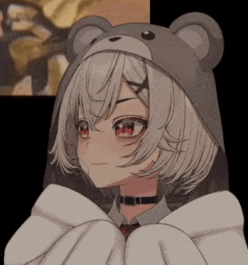 a girl with white hair and red eyes is wearing a bear hat