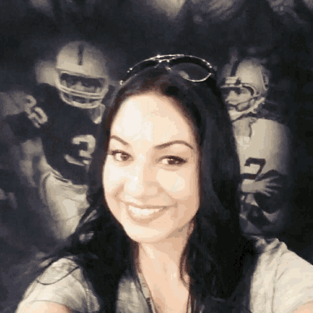 a woman wearing sunglasses smiles in front of a football player wearing a number 3 jersey