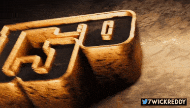 a close up of a gold block with the letters fg on it