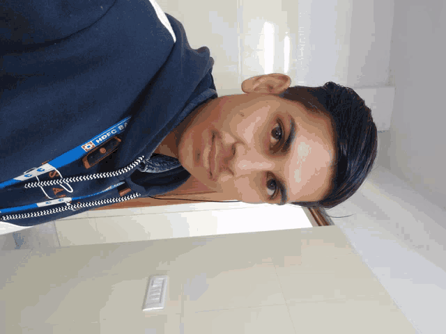 a young man wearing a blue hoodie that says hdfc bank on it