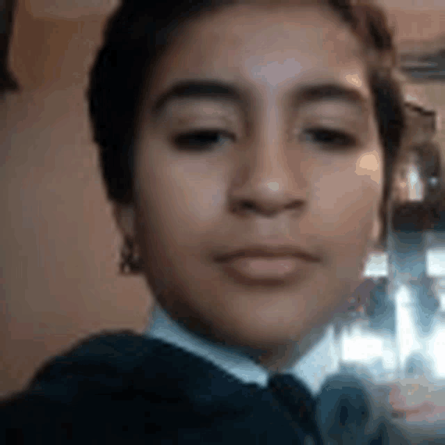 a young boy is taking a selfie with a camera .