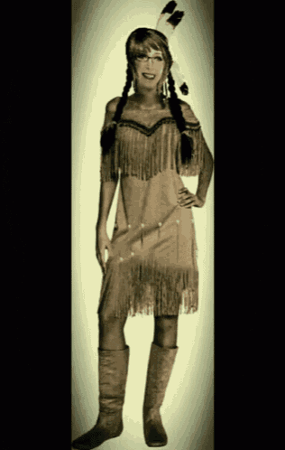 a woman dressed in a native american costume with fringe