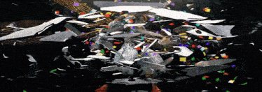 a person standing in front of a pile of broken glass and confetti