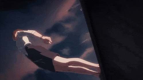 a woman in a white shirt and black shorts is hanging from a rope in the air