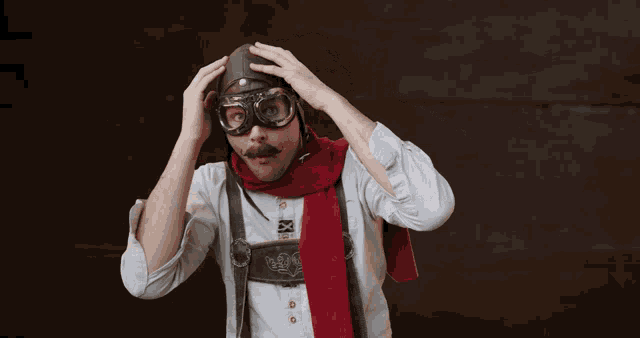 a man wearing a red scarf and a helmet with the letter x on it