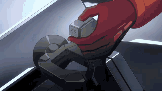 a hand in a red glove is holding a metal object with an arrow pointing up