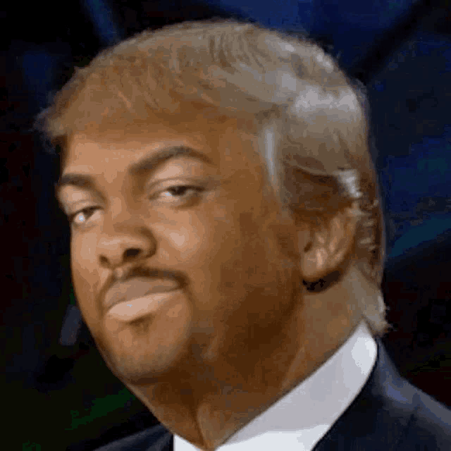 a close up of a man in a suit and tie with blonde hair and a mustache