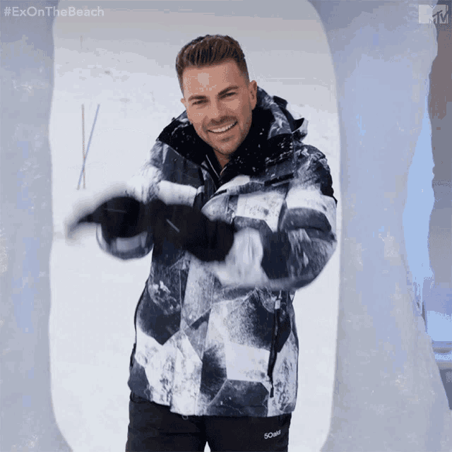 a man wearing a jacket that says exon the beach on the bottom