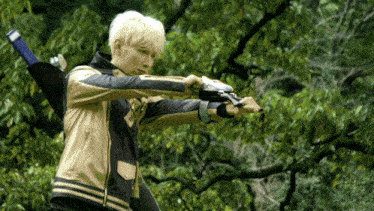 a man in a leather jacket is holding a blue object