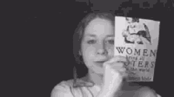 a black and white photo of a woman holding a book titled women 's rights