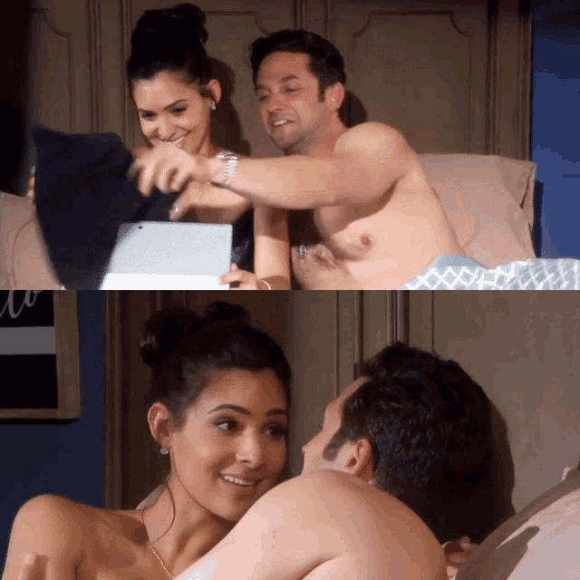 a man and a woman are laying on a bed with a tablet
