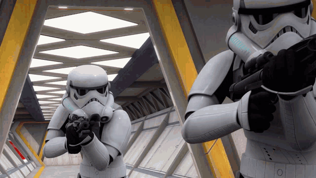 two storm trooper soldiers holding guns in a room