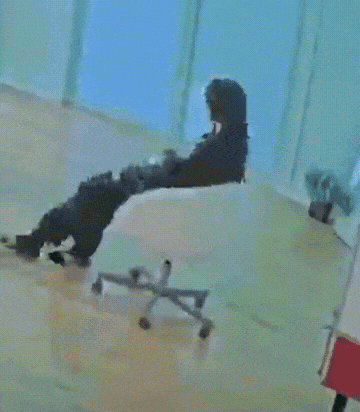 a person is sitting on a chair with their legs crossed