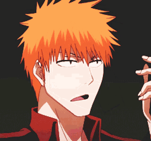 a man with orange hair and a red shirt making a funny face