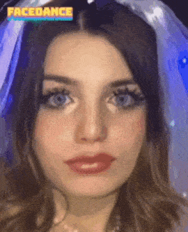 a close up of a woman 's face wearing a veil and a necklace .