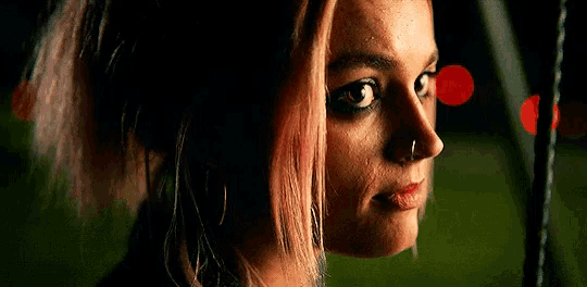a woman with a nose ring is looking at the camera