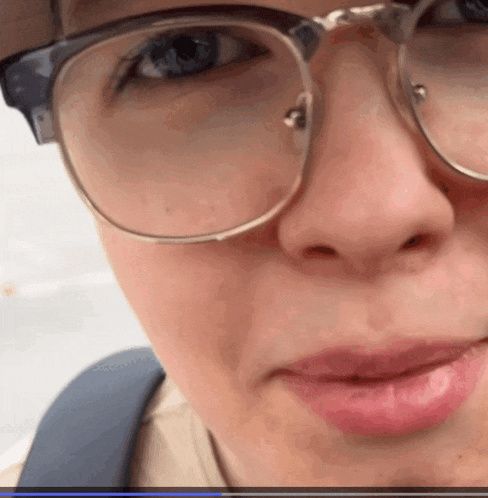 a close up of a person 's face with glasses