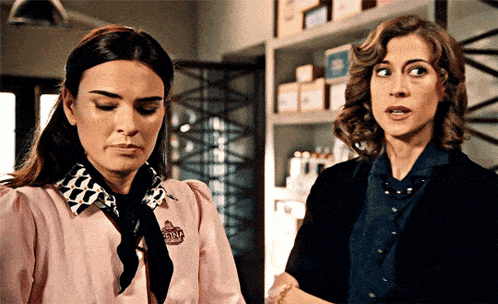 two women are standing next to each other with one wearing a shirt that says soap