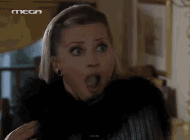 a woman with a surprised look on her face is being shown on a mega channel