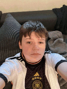 a young boy is taking a selfie while sitting on a couch