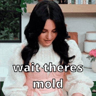 a woman in a pink and white dress with the words wait theres mold written on it