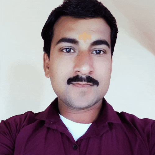 a man with a mustache and a bandage on his forehead
