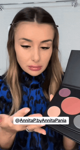 a woman holding a makeup palette with the name annitap by annitapania on the bottom