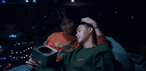 a man wearing a green sweatshirt that says ' tommy hilfiger ' on the front