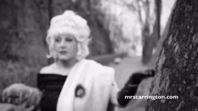 a black and white photo of a woman with the website mrscarrington.com on the bottom