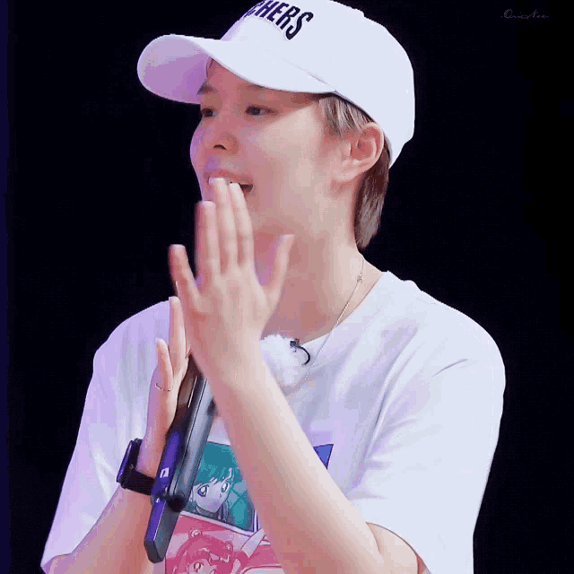a person wearing a white hat that says others on it