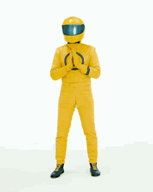 a man in a yellow suit with a helmet on his head is standing in front of the word thanks