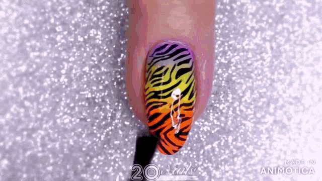 a close up of a person 's nails with a zebra print on them