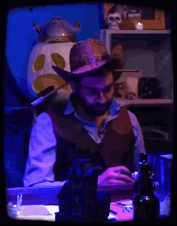 a man with a beard is holding a bow and arrow and says " this is how a gun works "