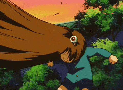 a boy in a blue shirt and shorts is holding a yellow and black blanket