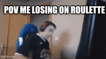 a man is sitting in a chair with a cat and the words pov me losing on roulette .