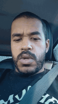 a man with a beard is wearing a black shirt that says ' sd ' on it
