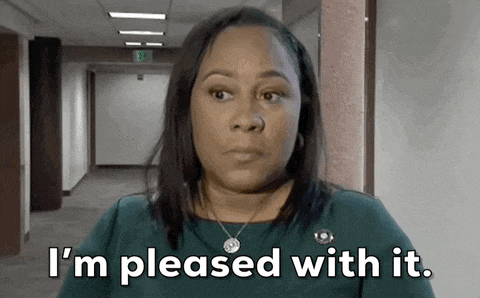 a woman says i 'm pleased with it while standing in a hallway