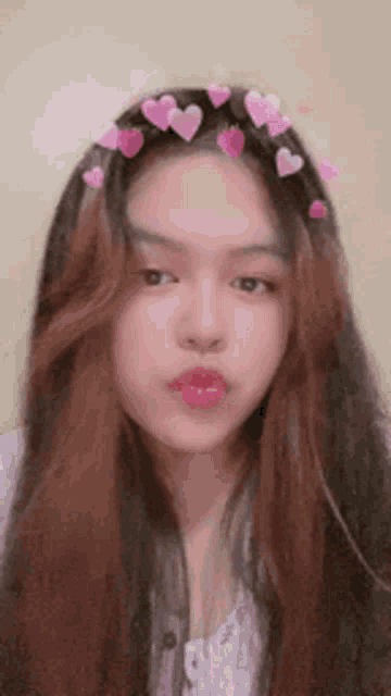 a girl with long hair and hearts on her head